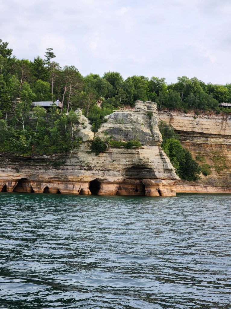 A view of a rock formation at Pictured Rocks National Lakeshore, from the perspective of someone on a boat in Lake Superior. 