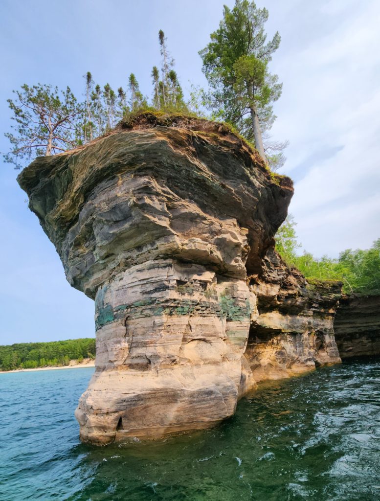 A rock formation that juts out from the land at Pictured Rocks National Lakeshore in Michigan, with Lake Superior around the other three sides. 