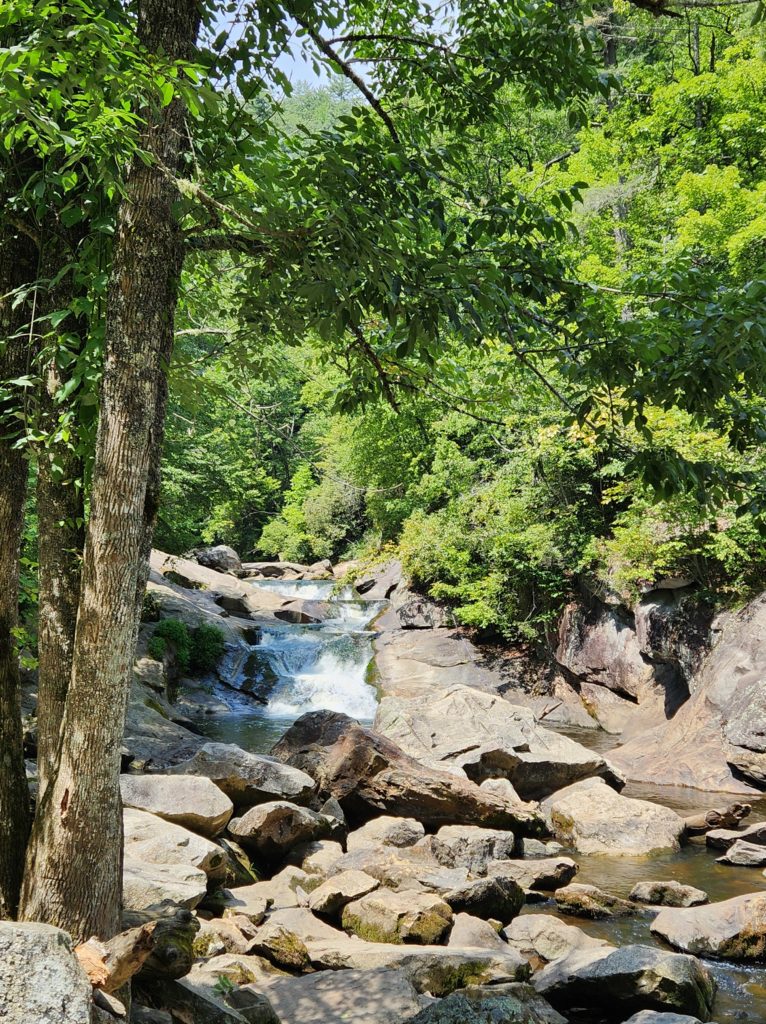 Quarry Falls, a.k.a. Bust Your Butt Falls, surrounded by large boulders and trees. One of the easy waterfalls near Franklin, NC.