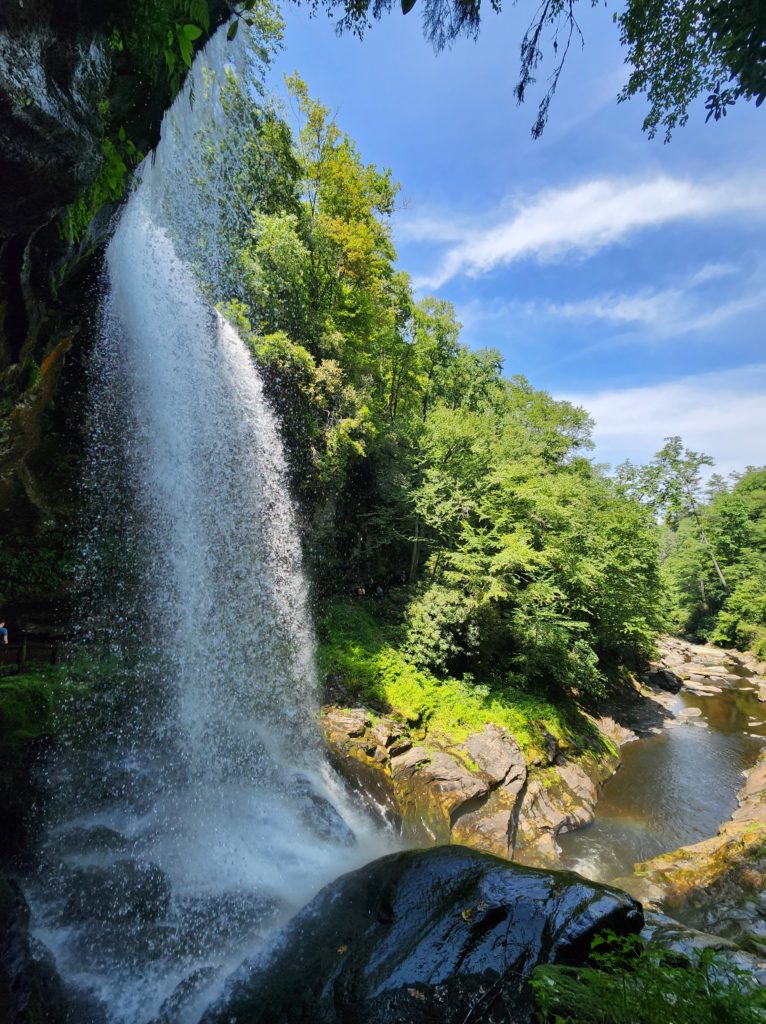 Behind Dry Falls in NC, looking through the waterfall and down over the river below. 