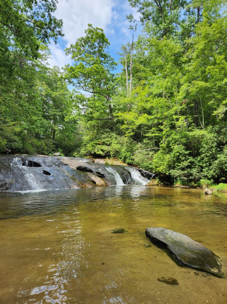 Cashier's Sliding Rock in NC, surrounded by trees.